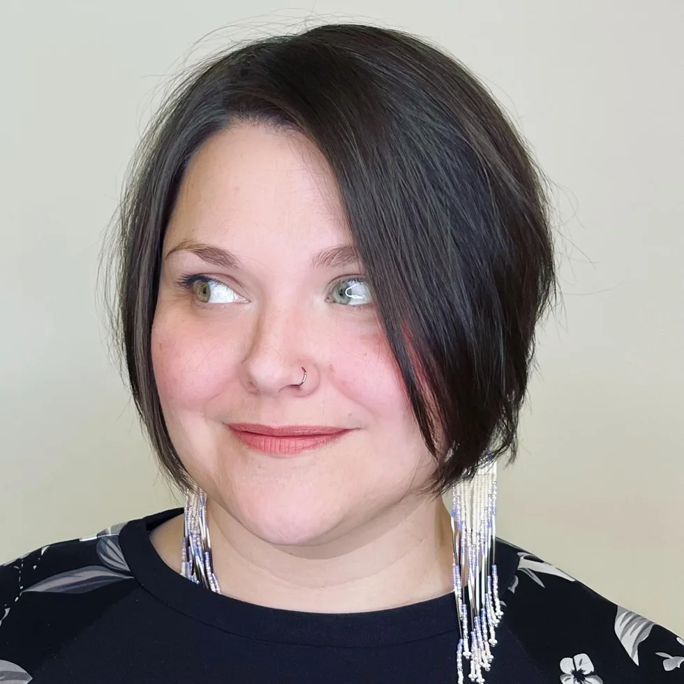 sleek black angled bob with a deep side part and a longer front panel on a round face with thin hair