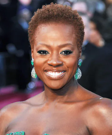 ear coily black curly style shown as a short natural hairstyles for black women over 50 idea, featuring natural finish, shown in black coily curly style with natural finish