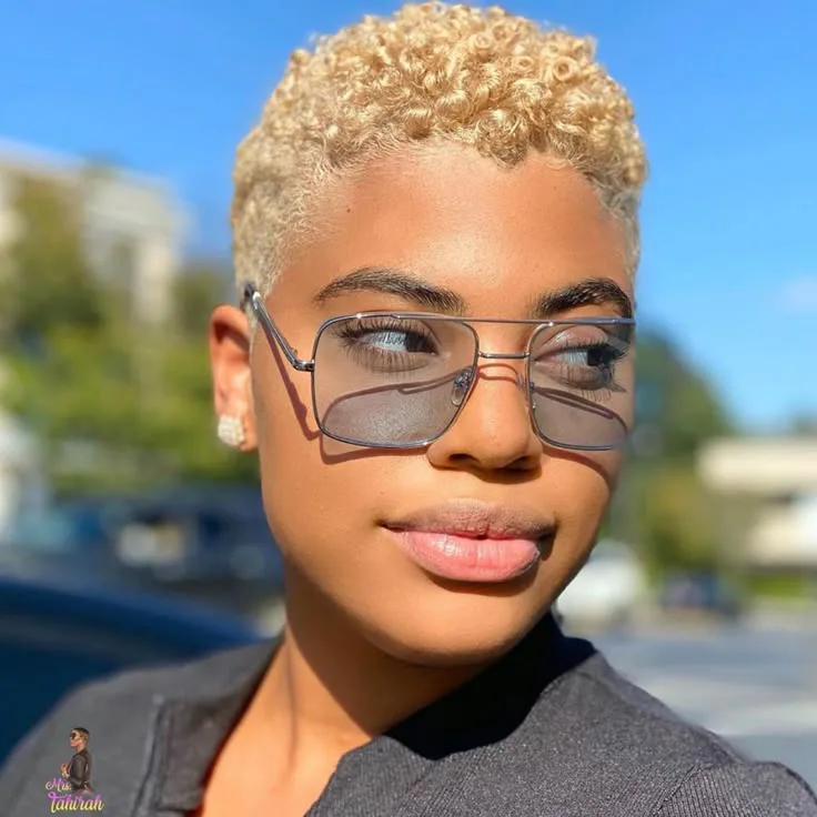 ear coily black curly style shown as a short natural hairstyles for black women over 50 idea, featuring volume through the all over