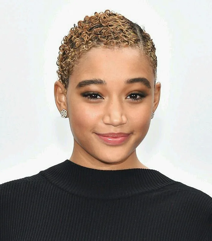 ear coily black curly style shown as a short natural hairstyles for black women over 50 idea, featuring black color
