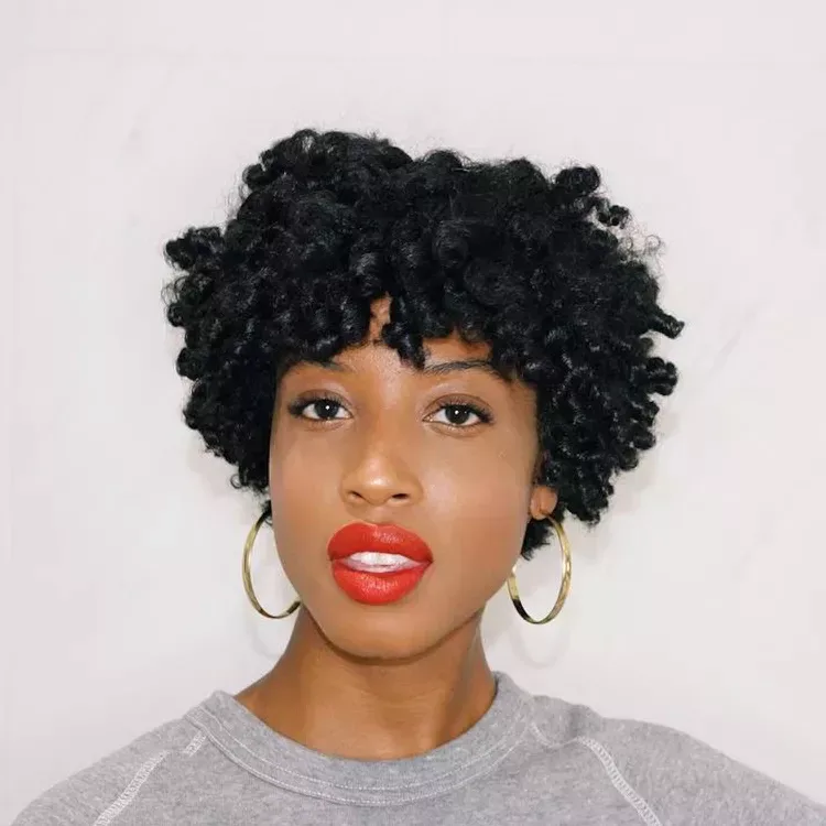 ear coily black curly style shown as a short natural hairstyles for black women over 50 idea, featuring ear outline, shown in black coily curly style with ear outline with ear outline