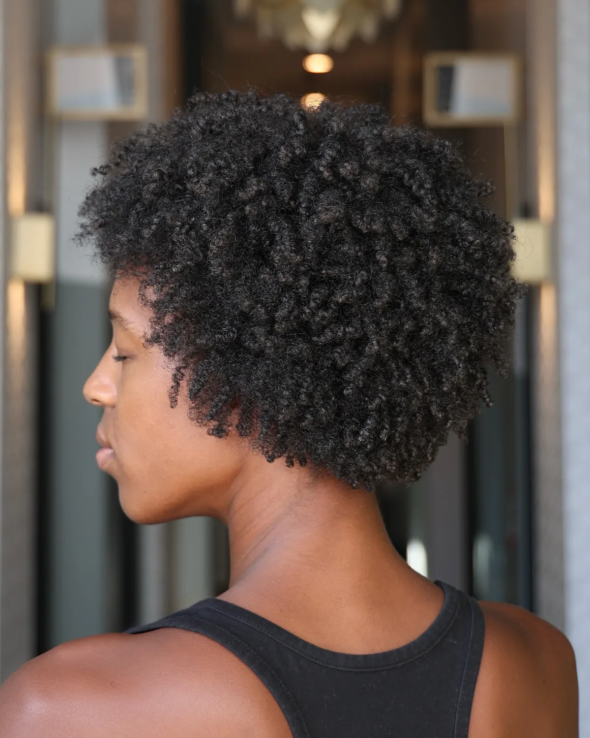 ear coily black curly style shown as a short natural hairstyles for black women over 50 idea, featuring natural finish, shown in black coily curly style with natural finish with natural finish with natural finish