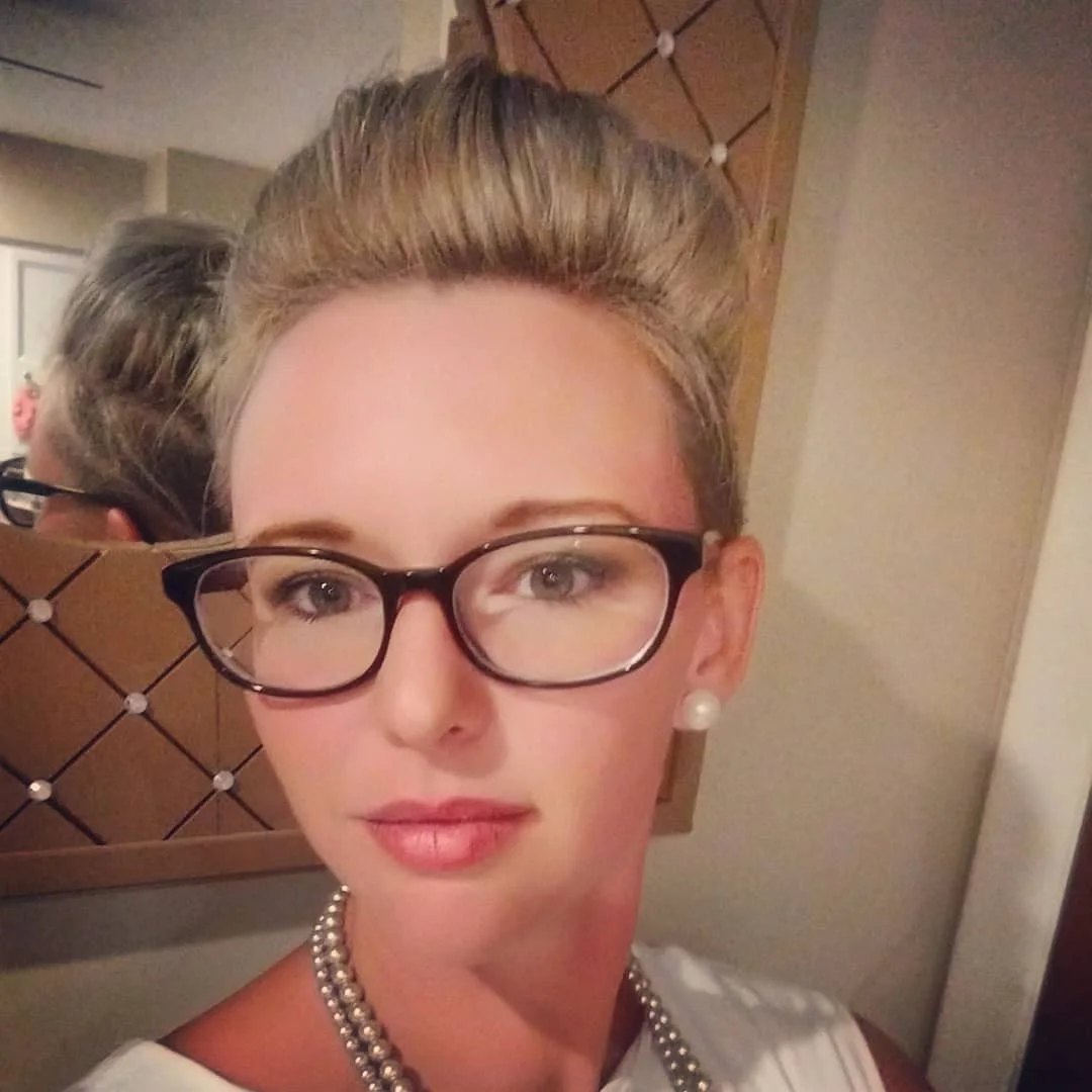 Lifted blonde pixie undercut with glasses and tall crown volume