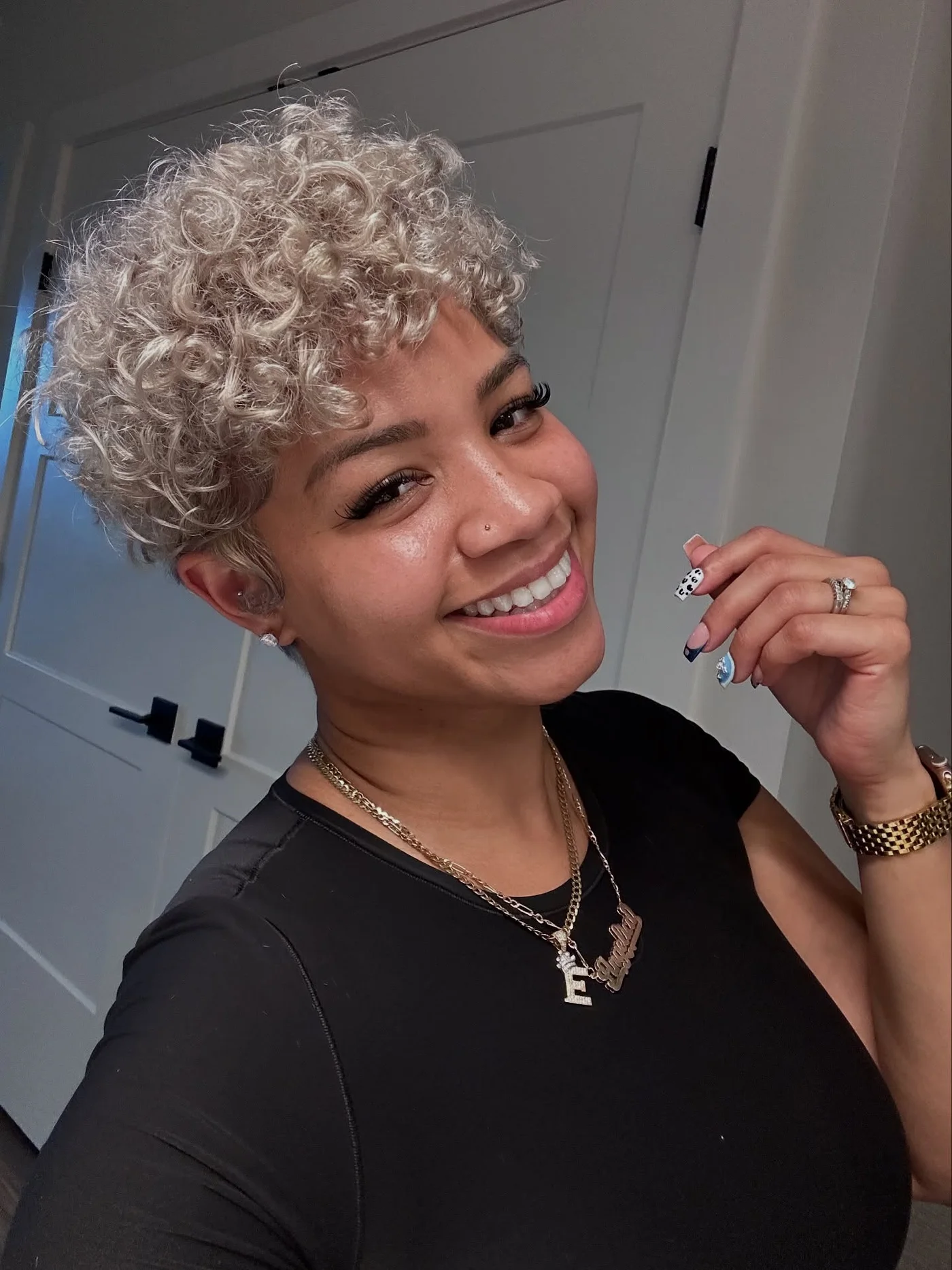 Silver curly pixie cut with cropped sides and lifted curls