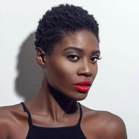 Minimal coily black pixie cut with very short natural texture