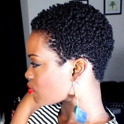 Side view of a coily black pixie cut with a tapered nape