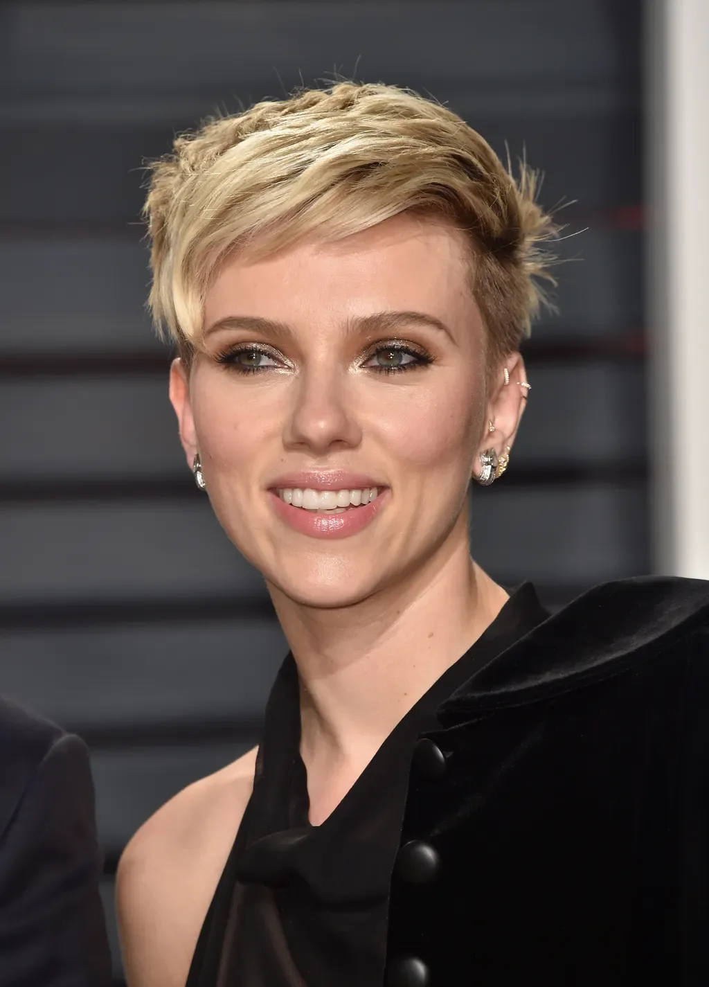 Polished blonde pixie cut with short side-swept layers