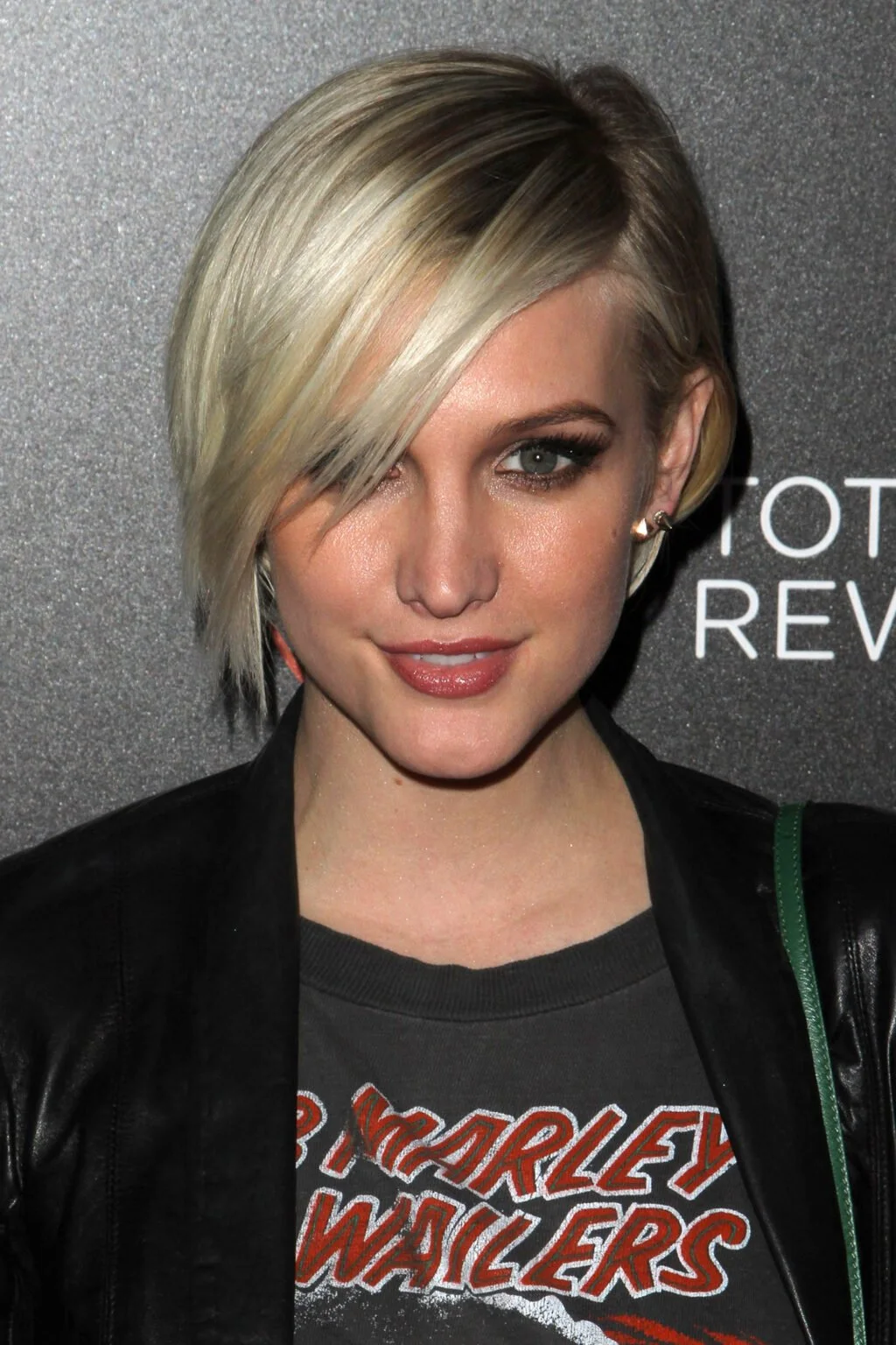 Long-fringe blonde pixie cut with a smooth side-swept front