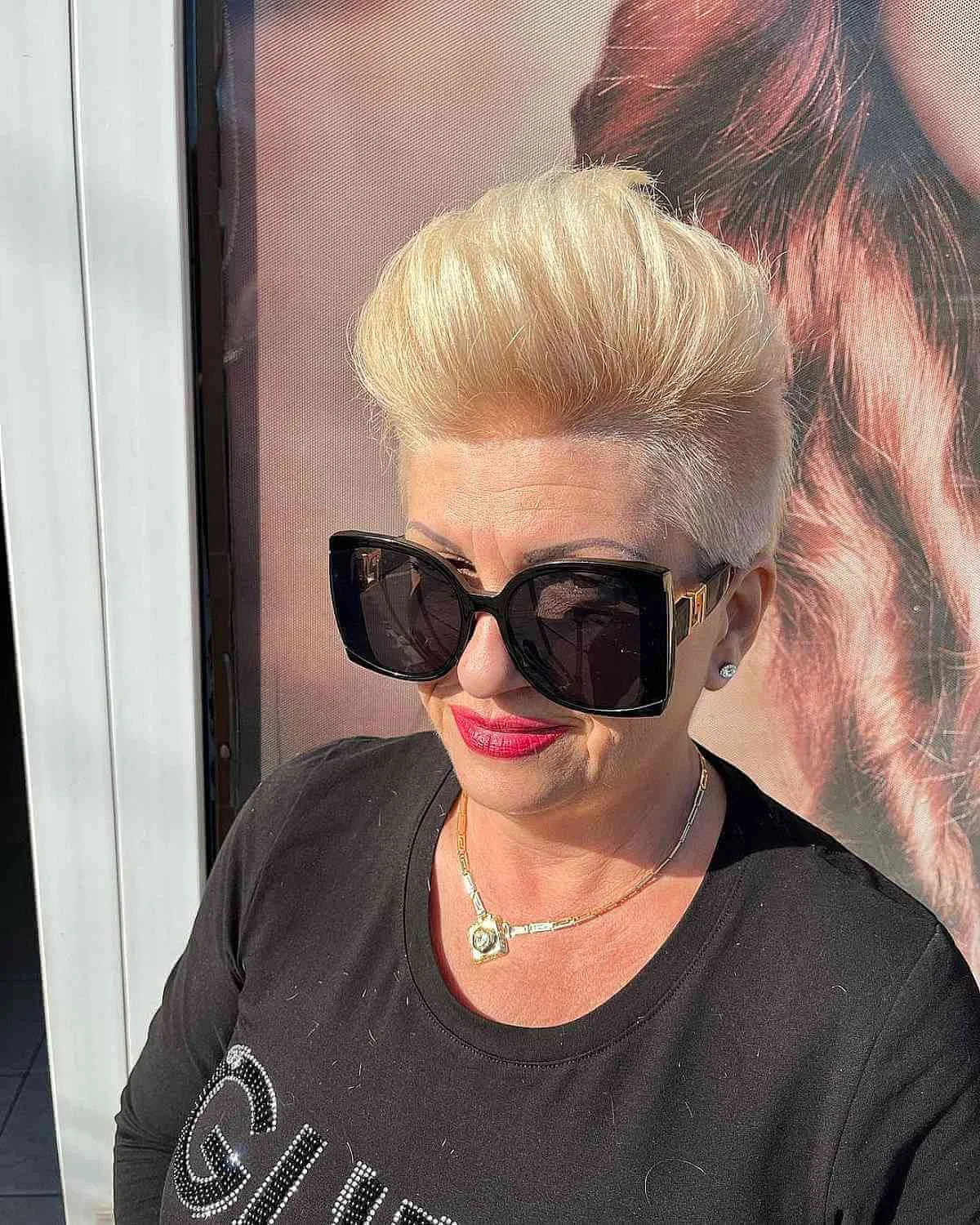 Platinum pompadour short pixie haircut for an older woman with sunglasses