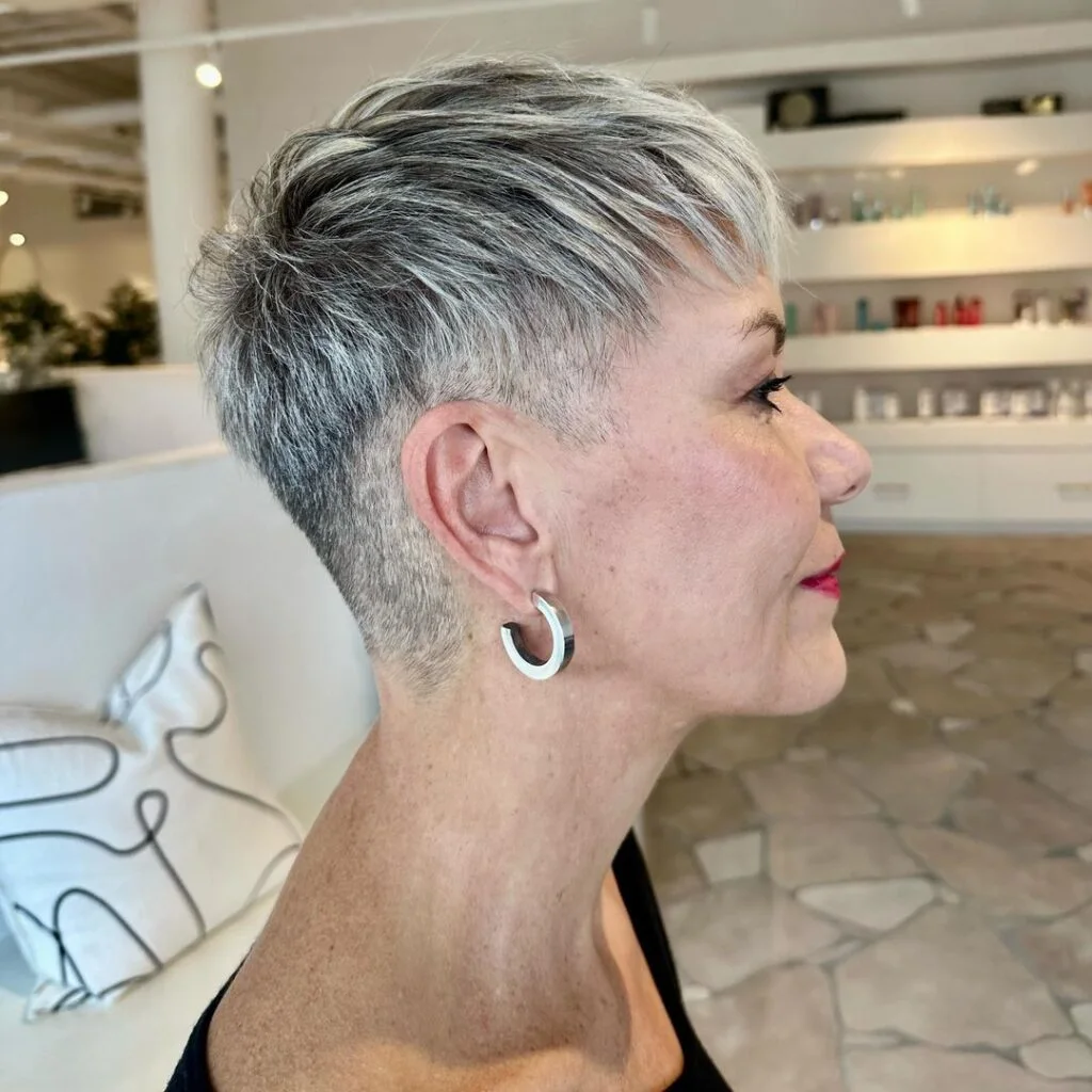 Tapered silver short pixie haircut for an older woman with close sides