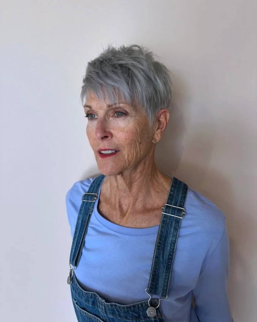 Feathered gray short pixie haircut for an older woman with soft crown texture