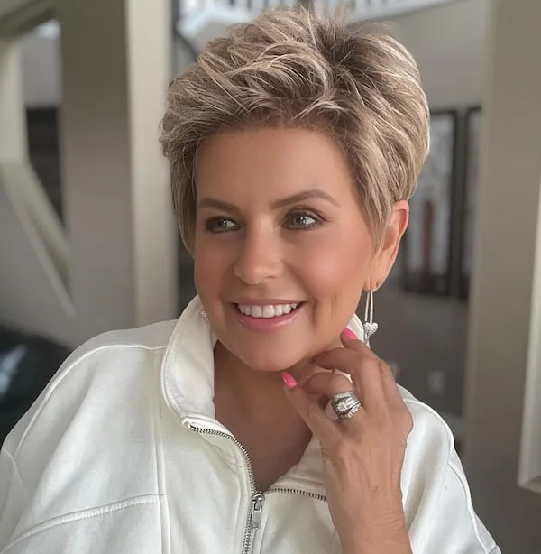 Taupe blonde short pixie haircut for an older woman with soft volume