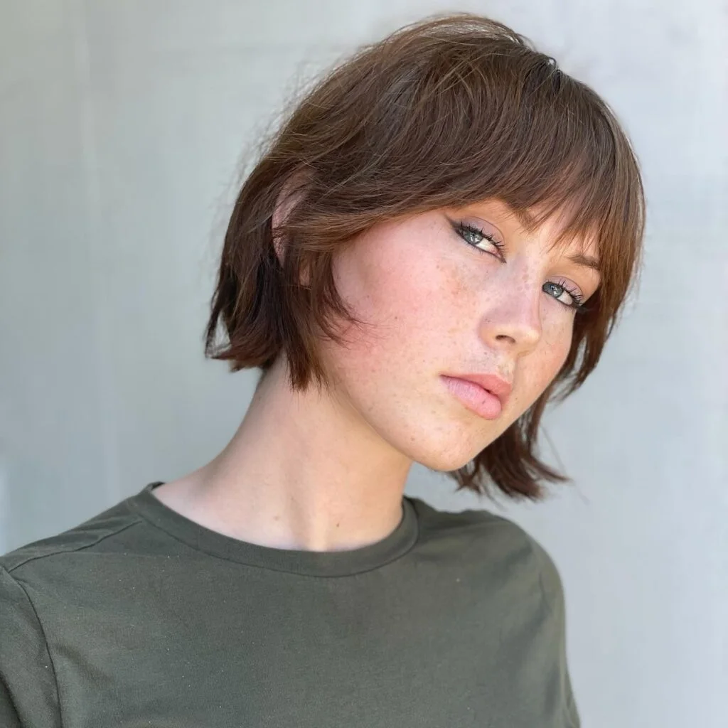 jaw wavy chestnut bob with side swept fringe shown as a short shaggy hair idea