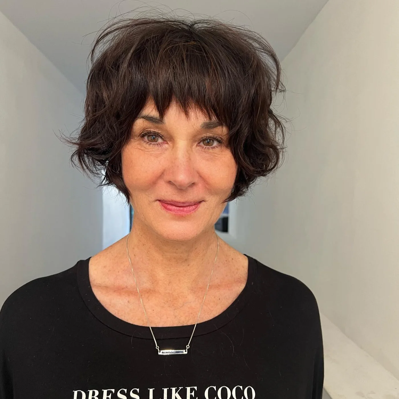 neck wavy brunette shag with wispy fringe shown as a short shaggy hair idea