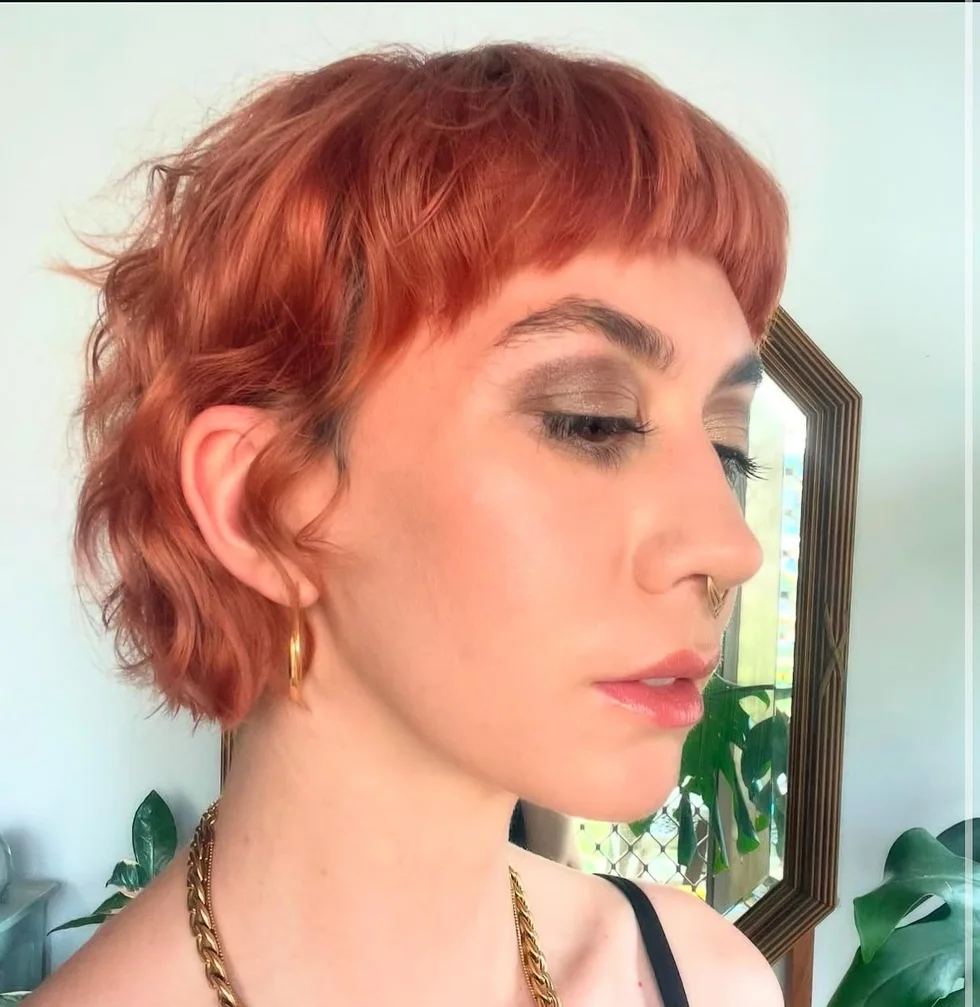 chin wavy copper color with micro fringe shown as a short shaggy hair idea, featuring copper color