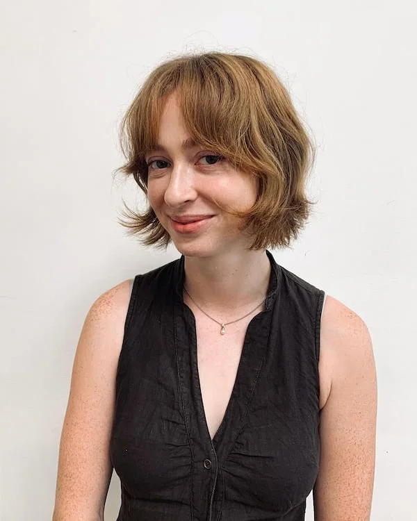 shoulder wavy chestnut shag with curtain fringe shown as a short shaggy hair idea, featuring curtain fringe