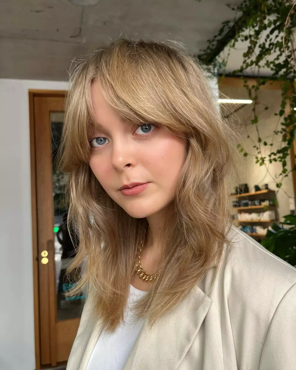 chest wavy blue color with curtain fringe shown as a short wolf curtain bangs idea