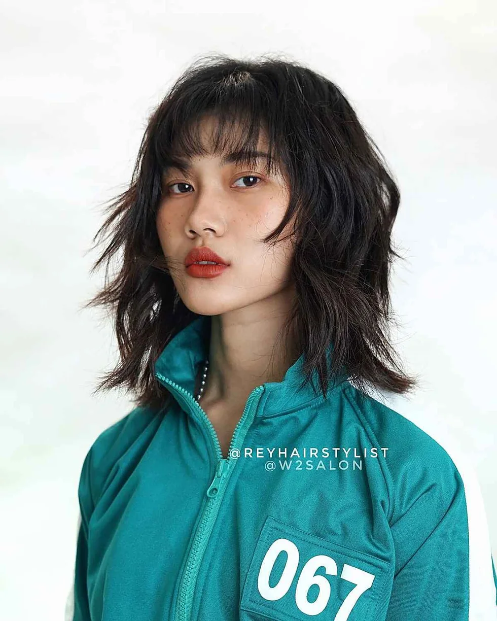 shoulder wavy black shag with shag fringe fringe shown as a short wolf curtain bangs idea
