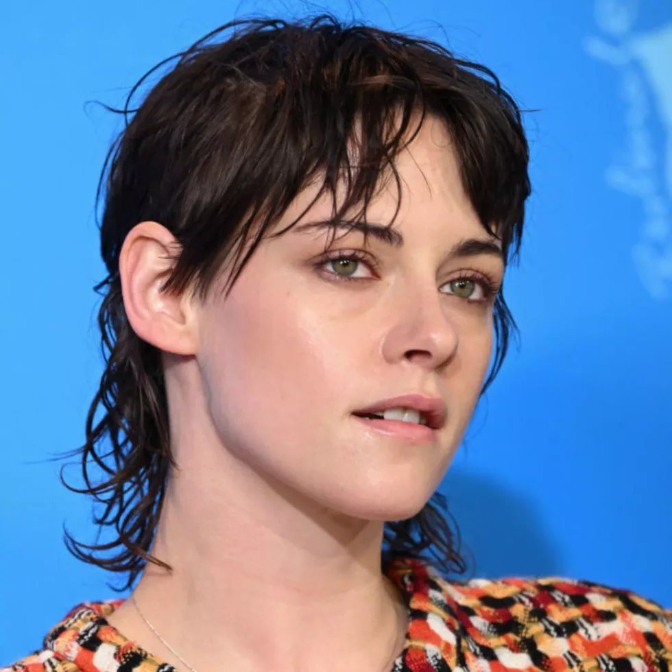 ear straight chestnut pixie with side swept fringe shown as a short wolf curtain bangs idea