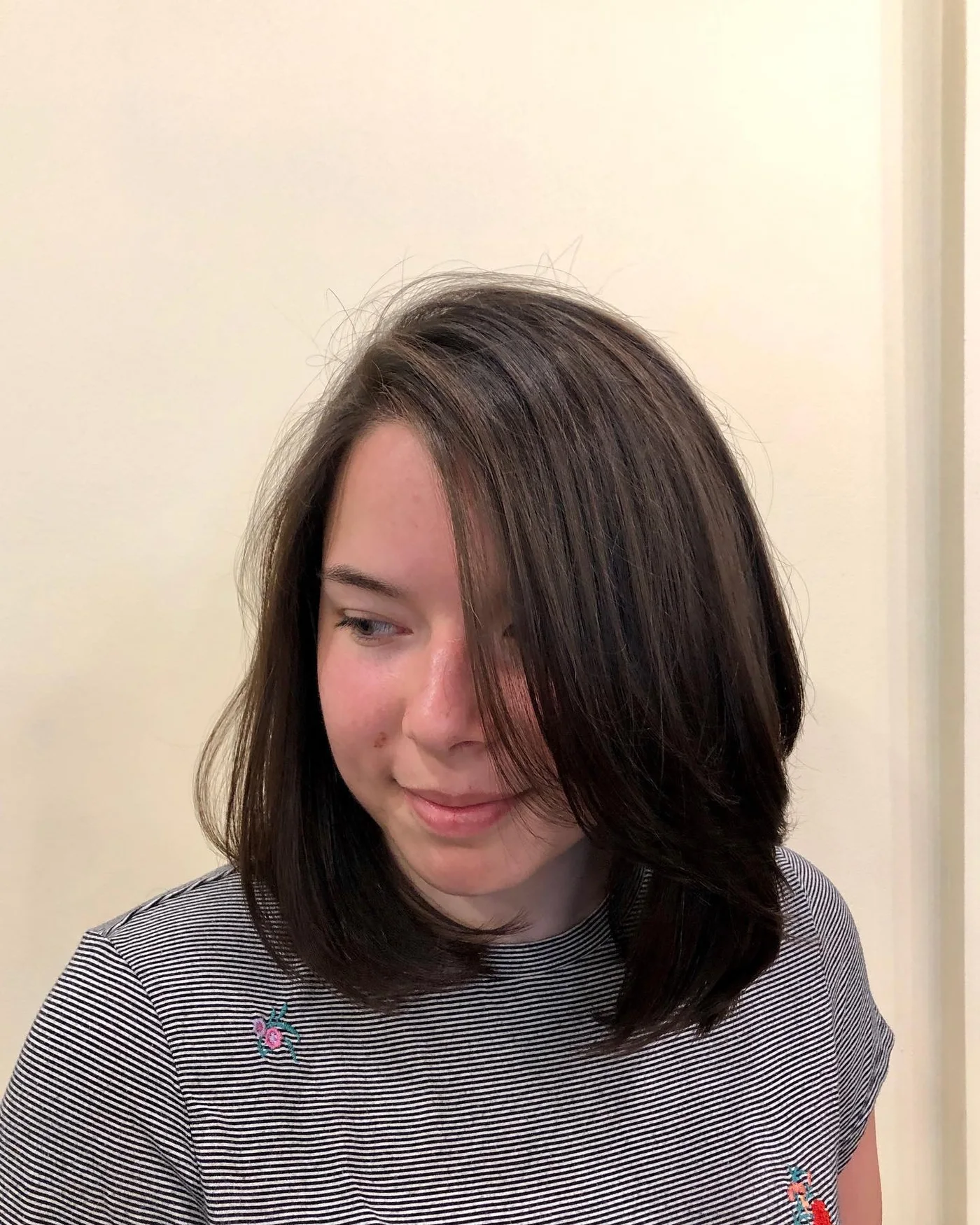 Angled shoulder length lob for thin fine hair with a longer front panel