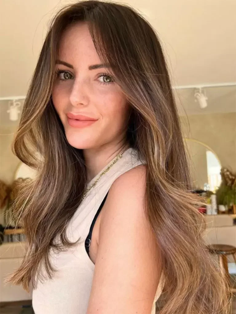 chest wavy black braid shown as a simple wedding guest hair idea