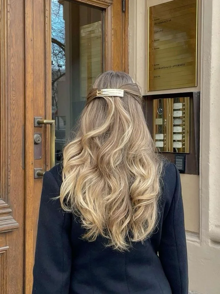 chest wavy honey half up shown as a simple wedding guest hair idea