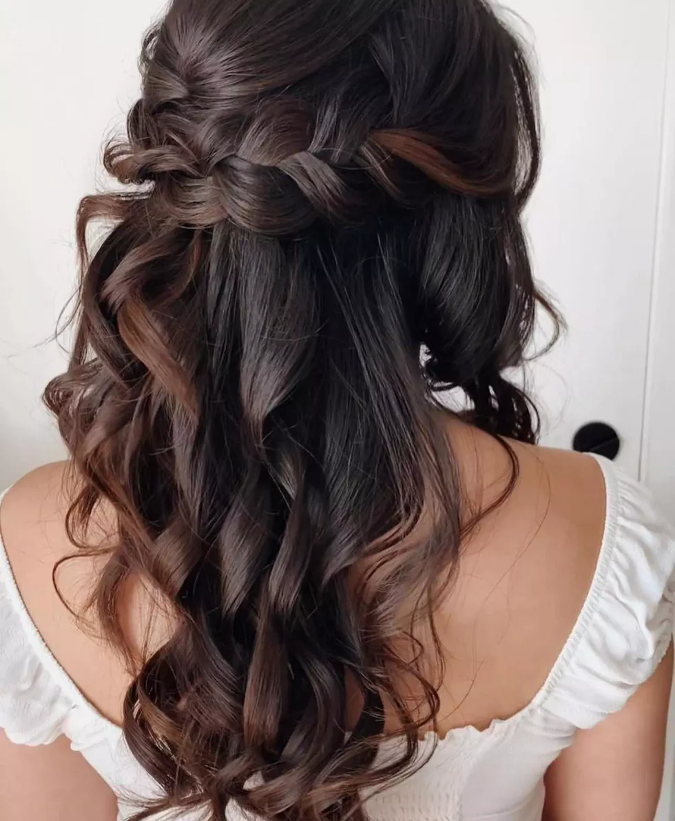 chest straight black ponytail shown as a simple wedding guest hair idea