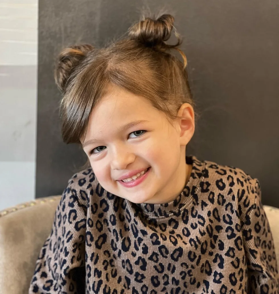 shoulder straight brunette bun shown as a space buns idea, featuring straight texture