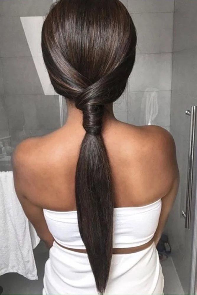 Back view of a straight dark low ponytail with a broad wrapped base