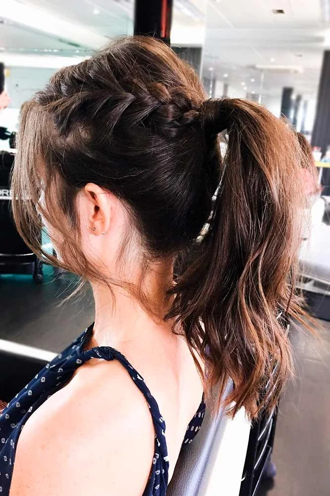 Side view of brown hair with a raised side braid joining a high ponytail
