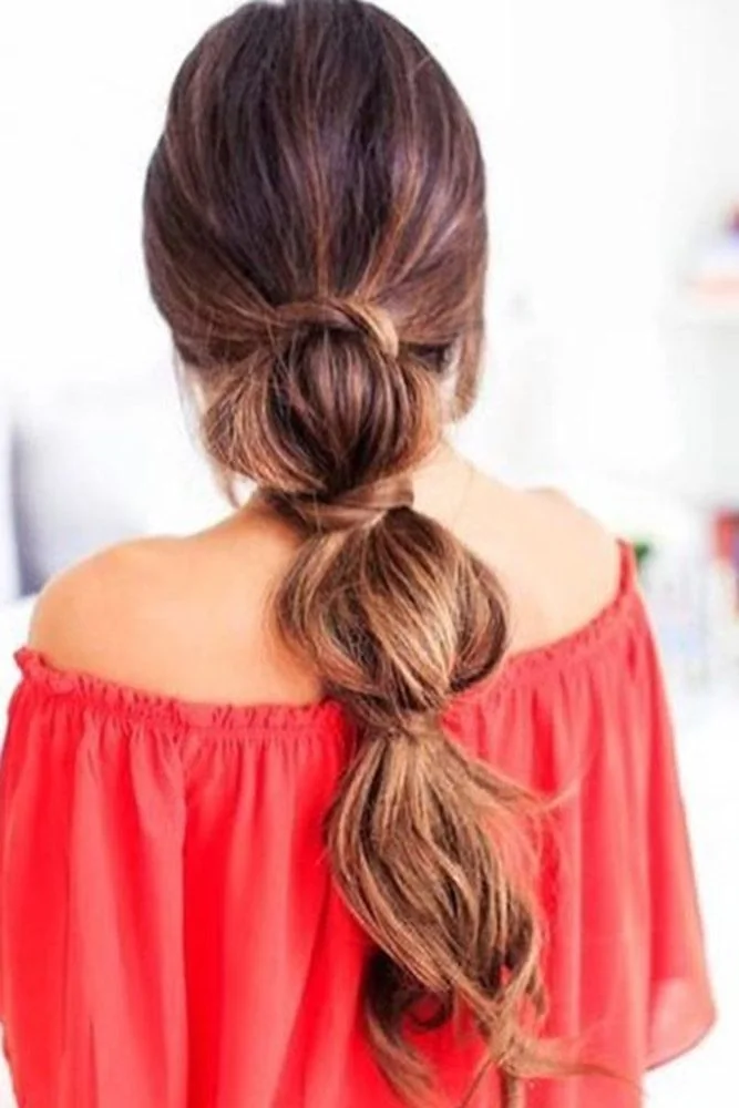 Back view of a low brown ponytail divided into rounded bubble sections