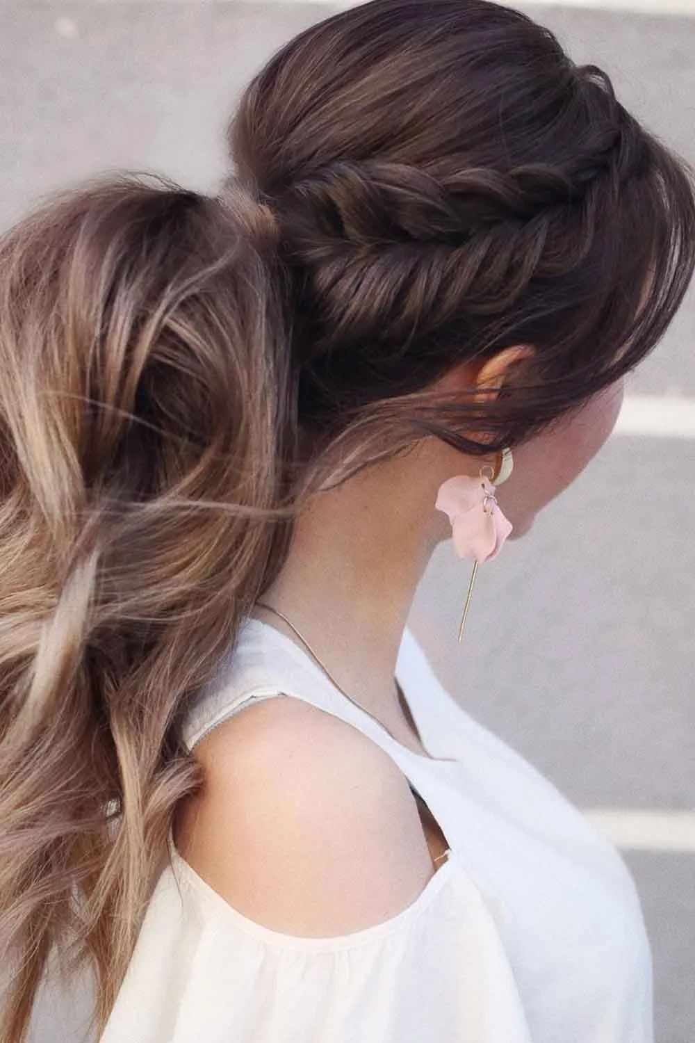 Side-back view of a brown ponytail with a raised braid above the ear