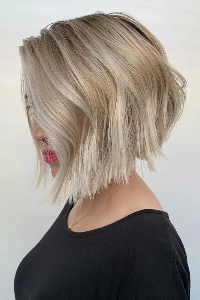 Side view of a blonde graduated bob with soft waves and longer pointed front ends
