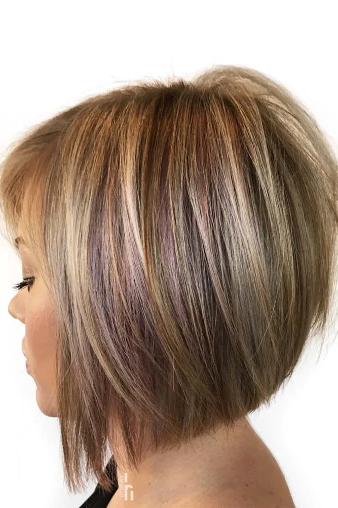 Side view of a brown highlighted bob with a rounded back and longer front strands