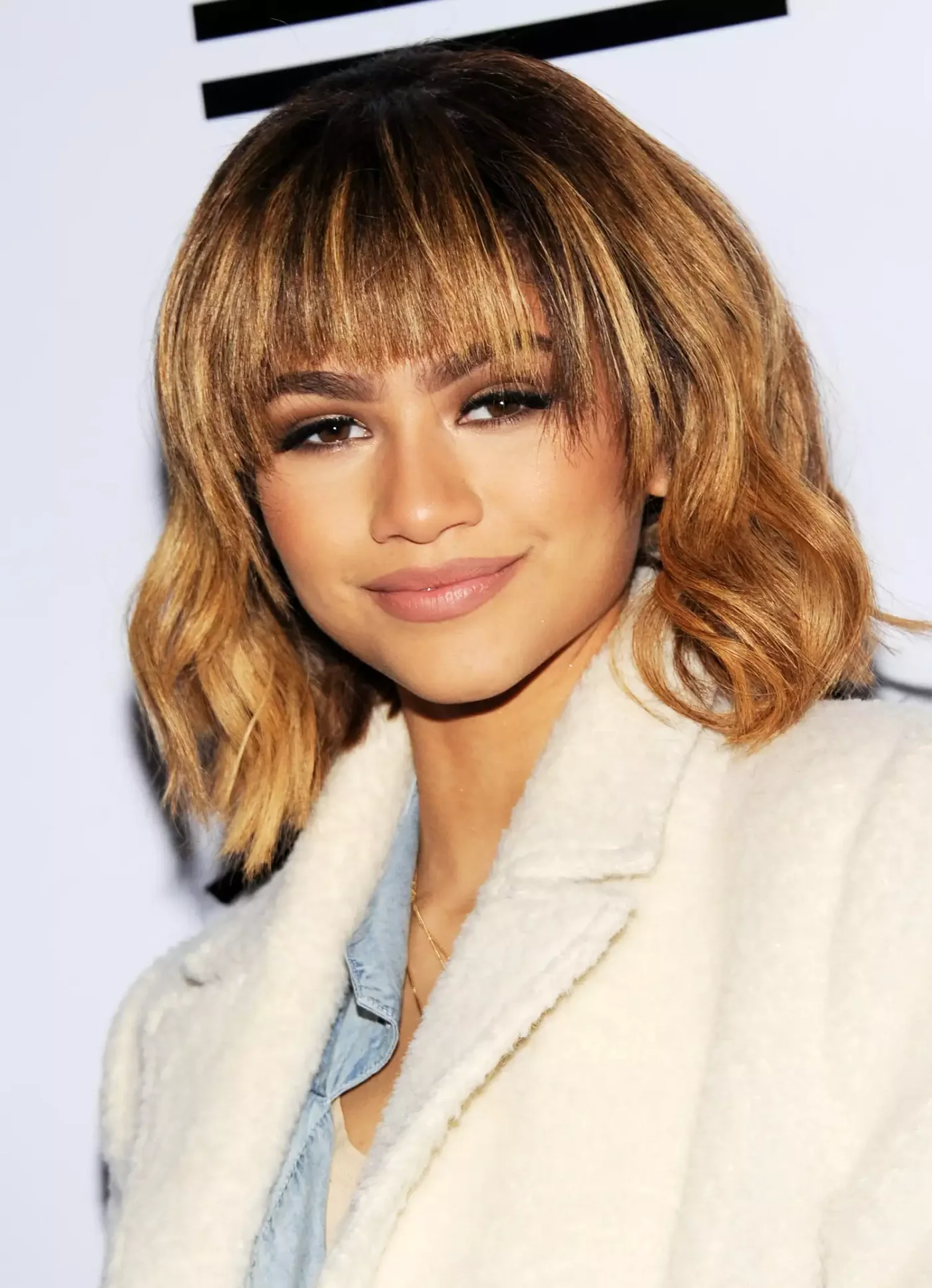 chin wavy blonde bob with wispy fringe shown as a textured bob for thin hair idea, featuring wispy fringe
