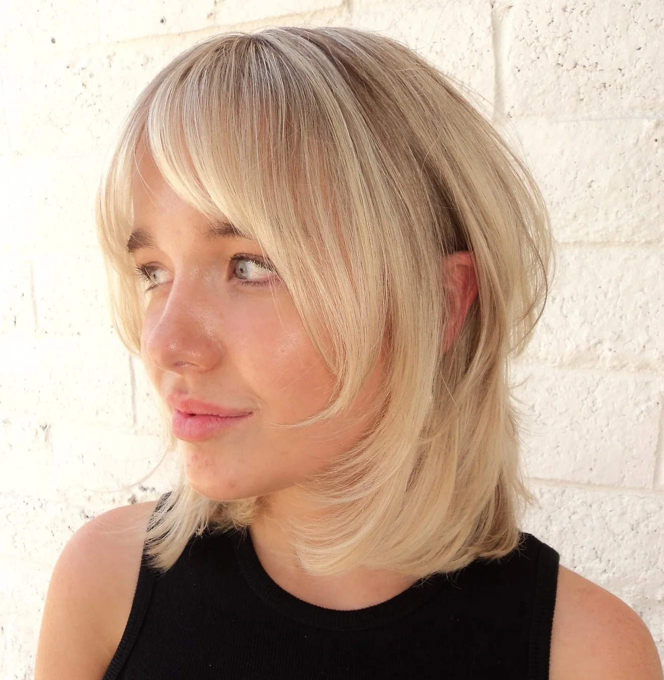 chin straight blonde bob with curtain fringe shown as a thin hairstyles round face idea