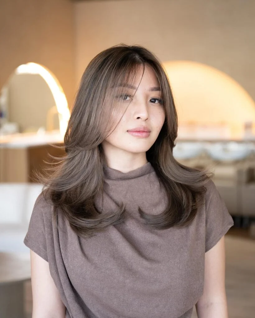 shoulder straight brunette layers with curtain fringe shown as a thin hairstyles with bangs idea
