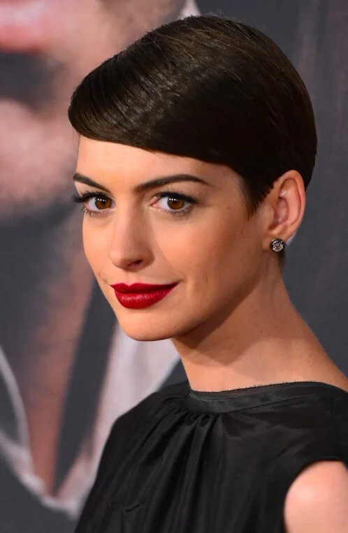 ear straight golden pixie with wispy fringe shown as a thin hairstyles with bangs idea, featuring volume through the crown
