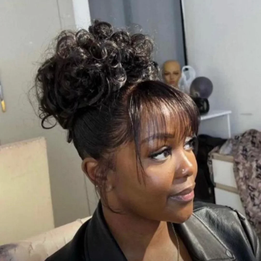 curly high puff updo with black curly hair styled as an updo for fine thin hair