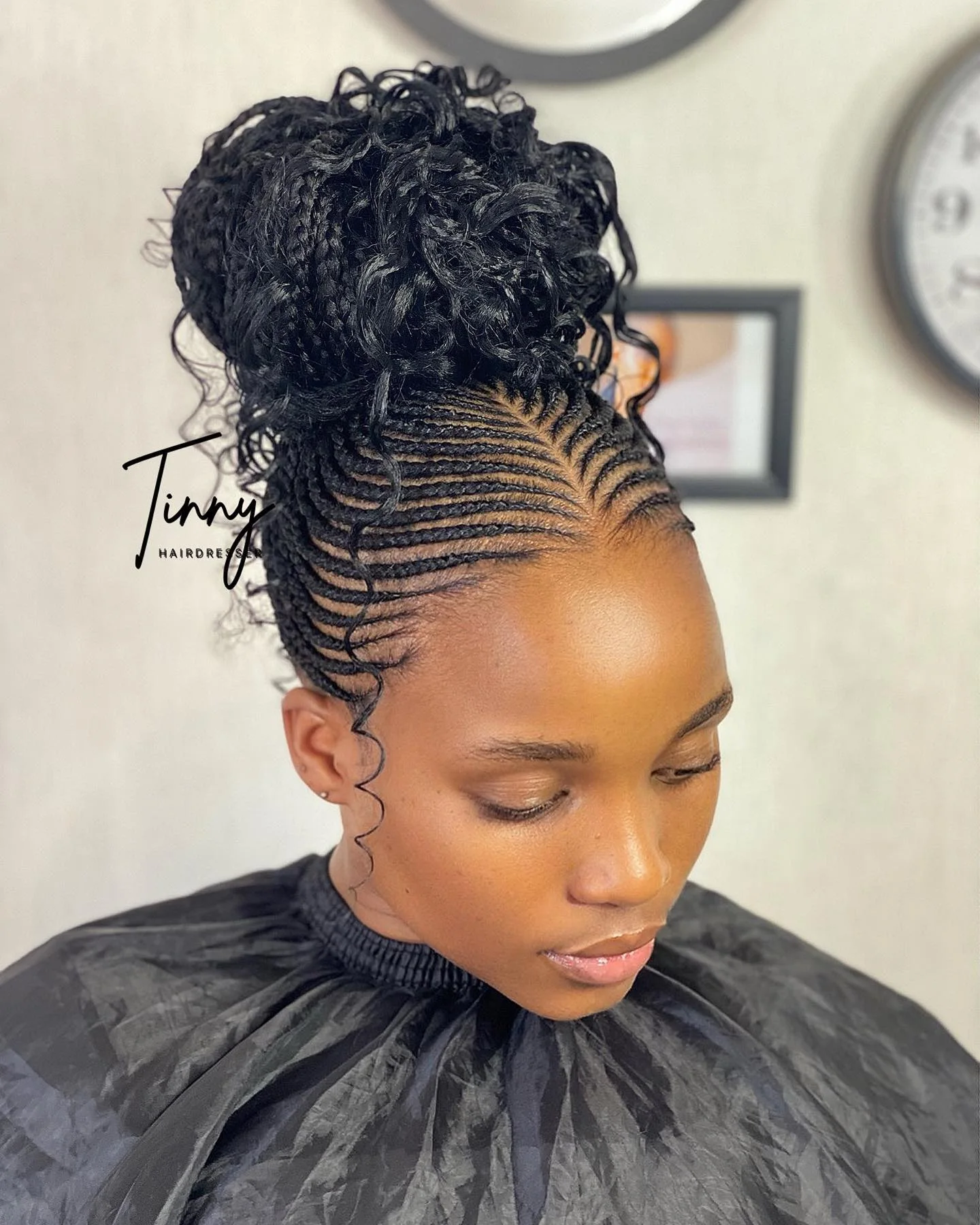 curly braided high bun with black braids hair styled as an updo for fine thin hair