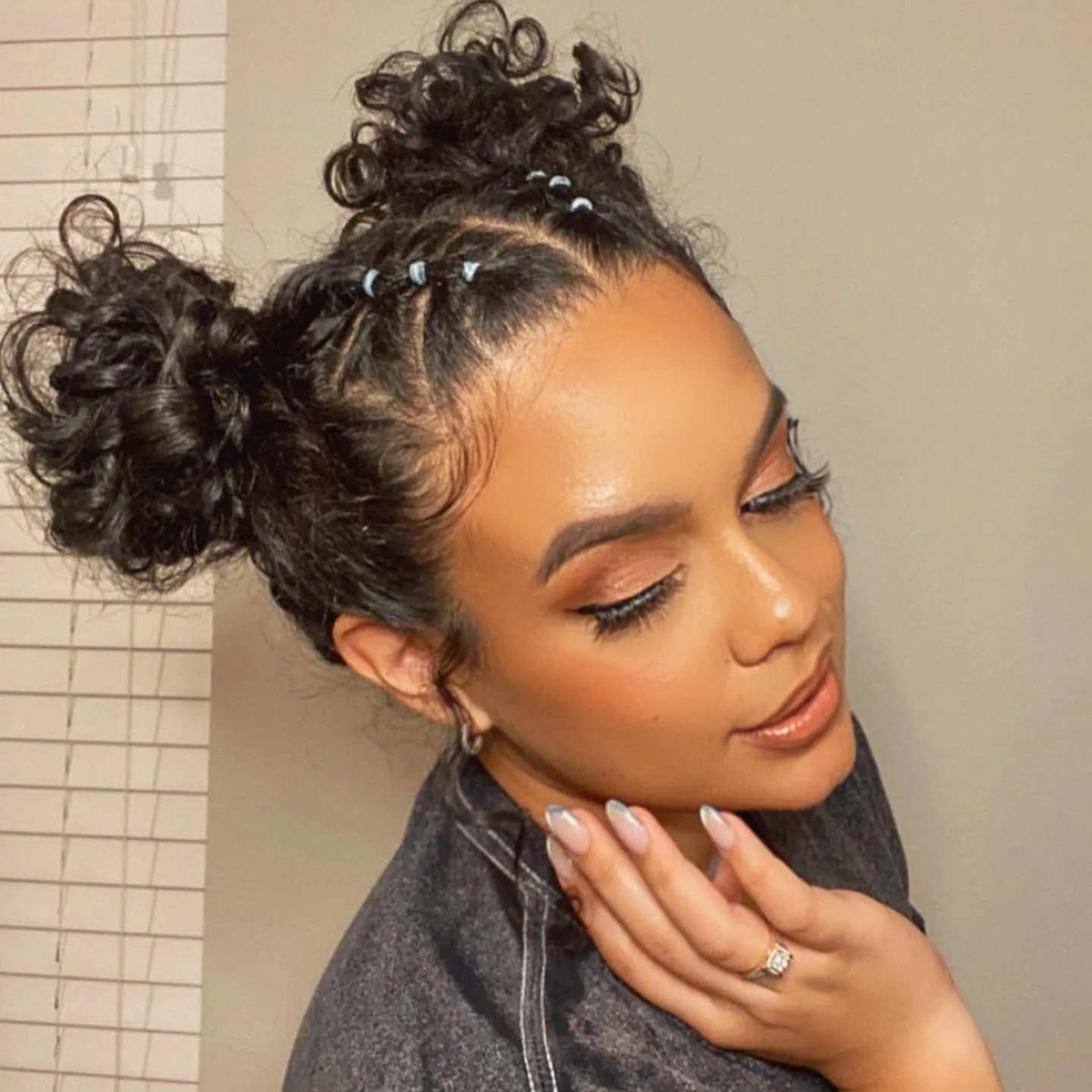 curly side bun updo with black braids hair styled as an updo for fine thin hair