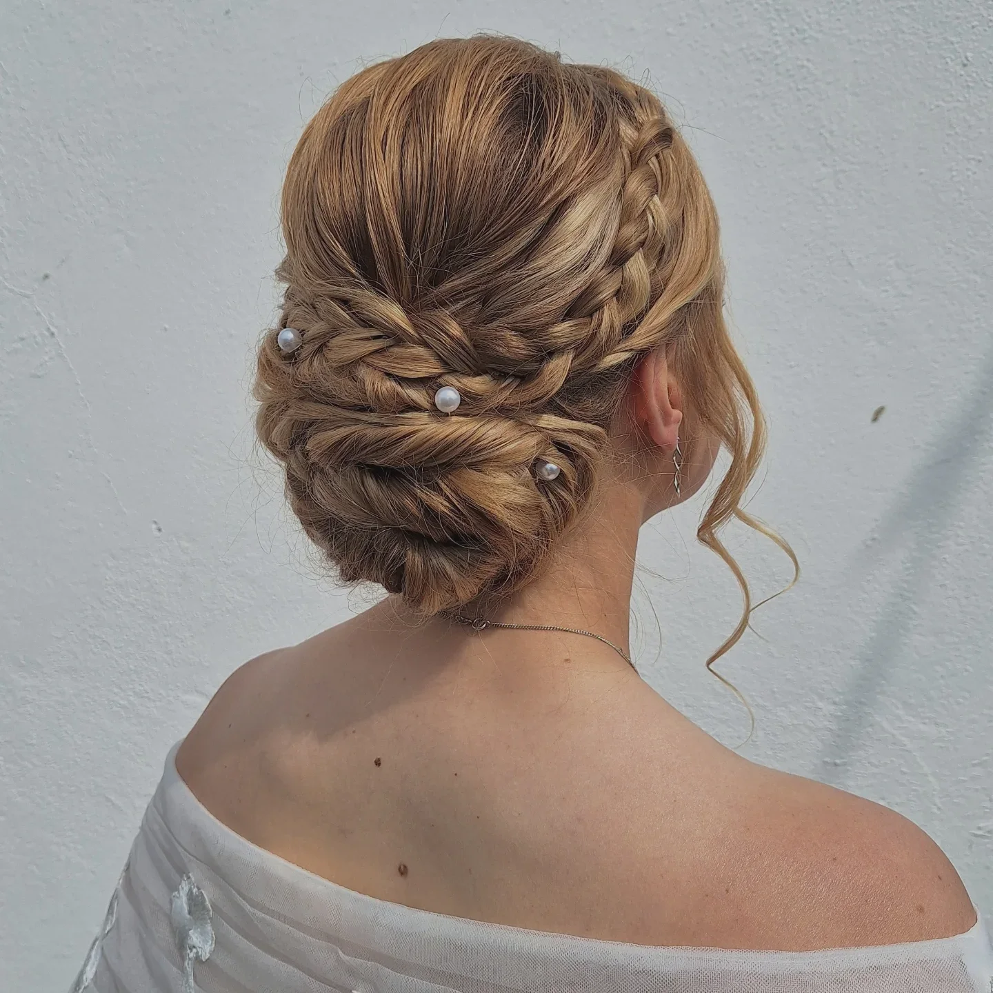 braided blonde low bun with brunette wavy hair styled as an updo for fine thin hair