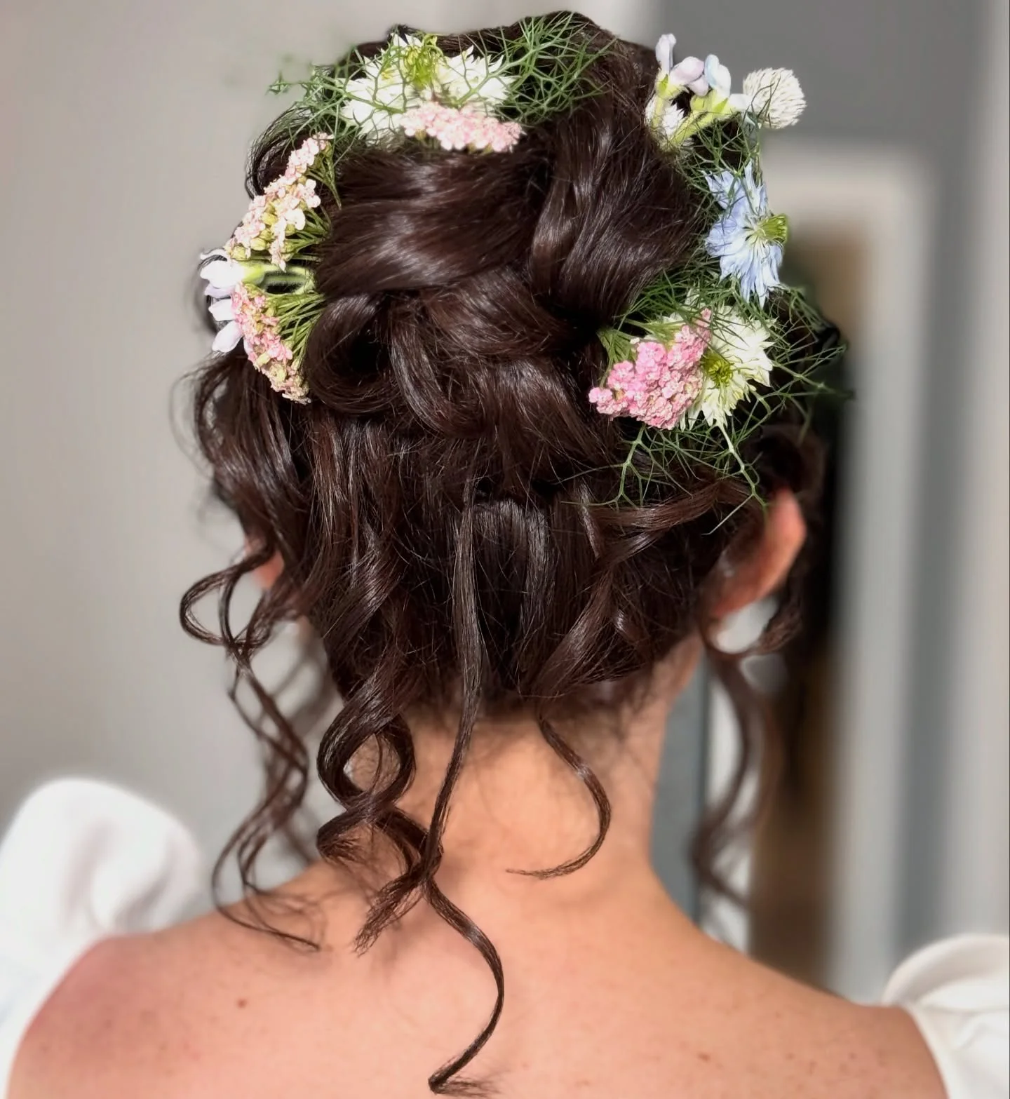 garden curly low updo with brunette curly hair styled as an updo for fine thin hair