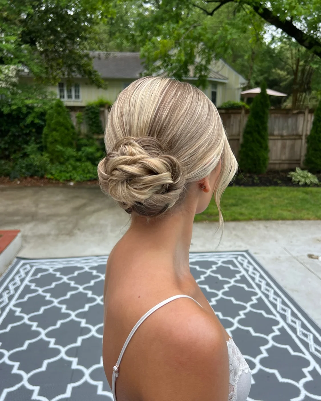 elegant blonde low chignon with blonde wavy hair styled as an updo for fine thin hair