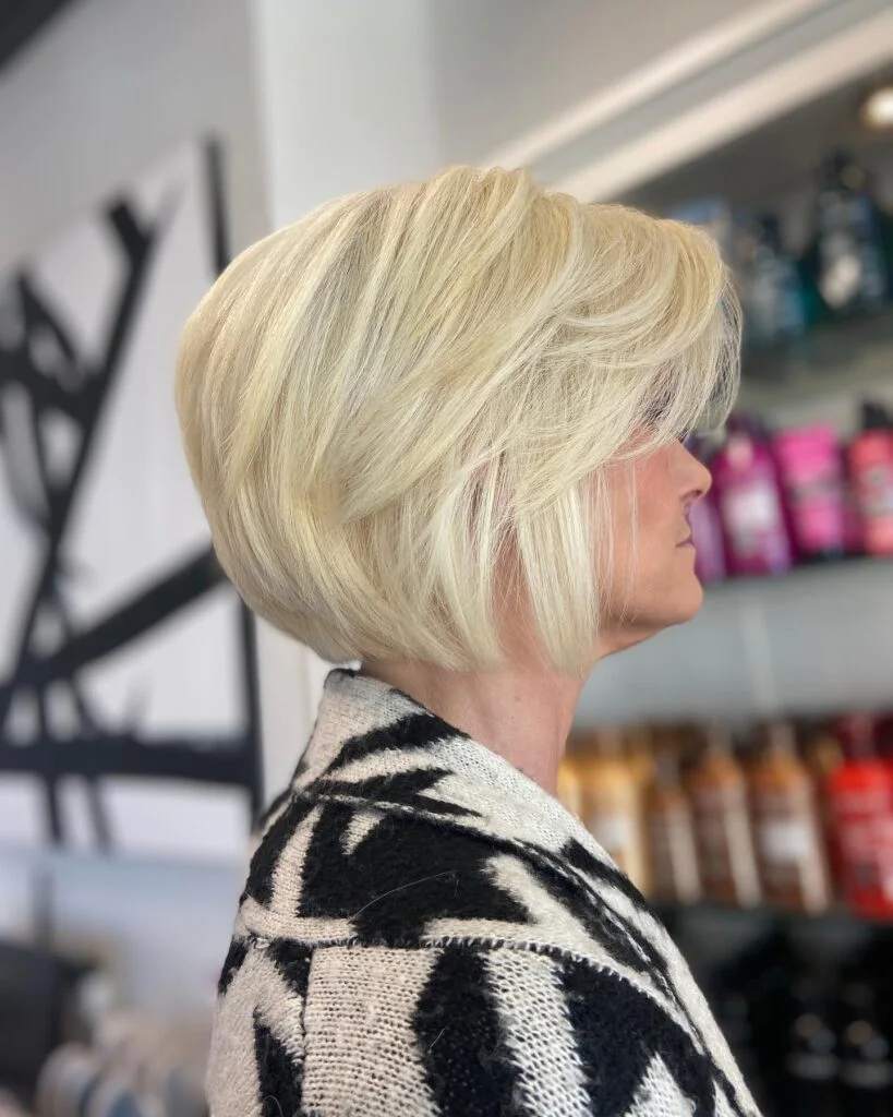 blonde stacked bob profile on a woman over 60 with an easy wash-and-wear haircut shape