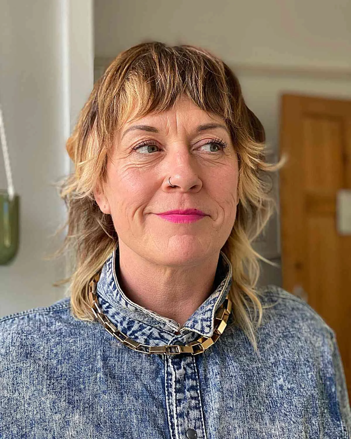 wavy shag with short bangs on a woman over 60 with an easy wash-and-wear haircut shape