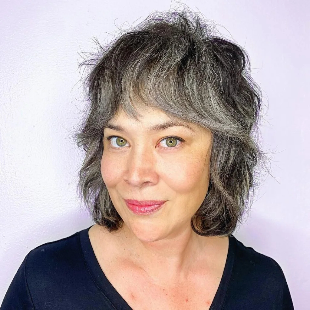 gray wavy shag bob on a woman over 60 with an easy wash-and-wear haircut shape