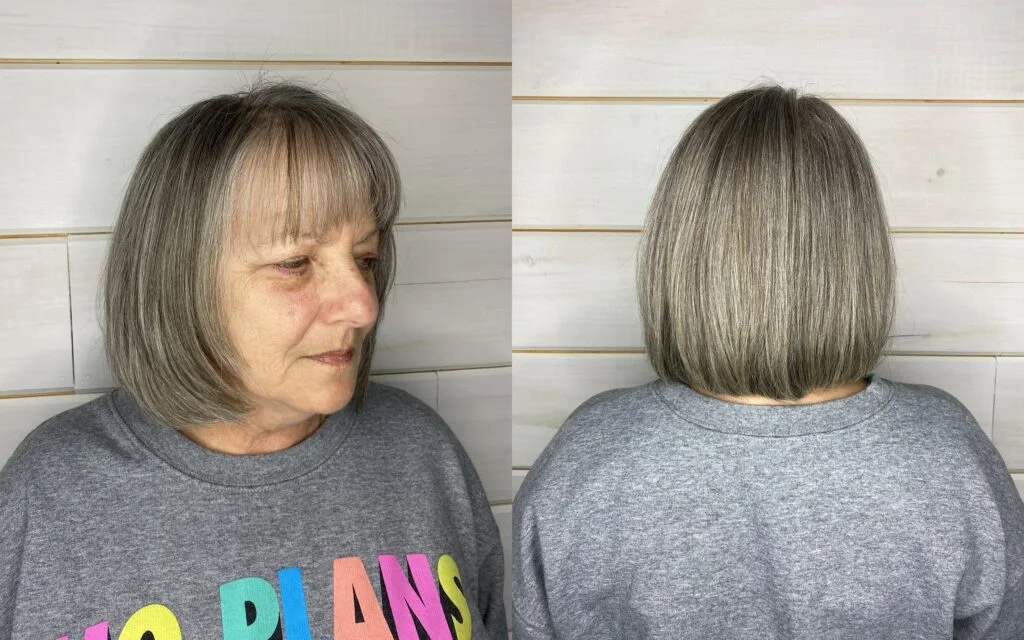 straight gray bob with bangs on a woman over 60 with an easy wash-and-wear haircut shape