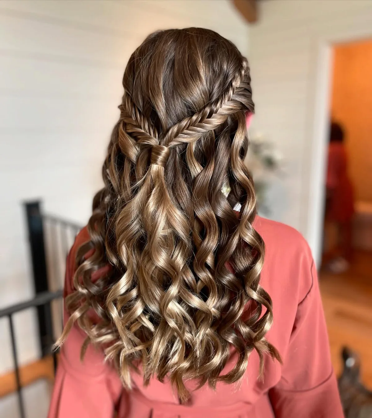 chest wavy brunette half up shown as a waterfall hairstyles idea