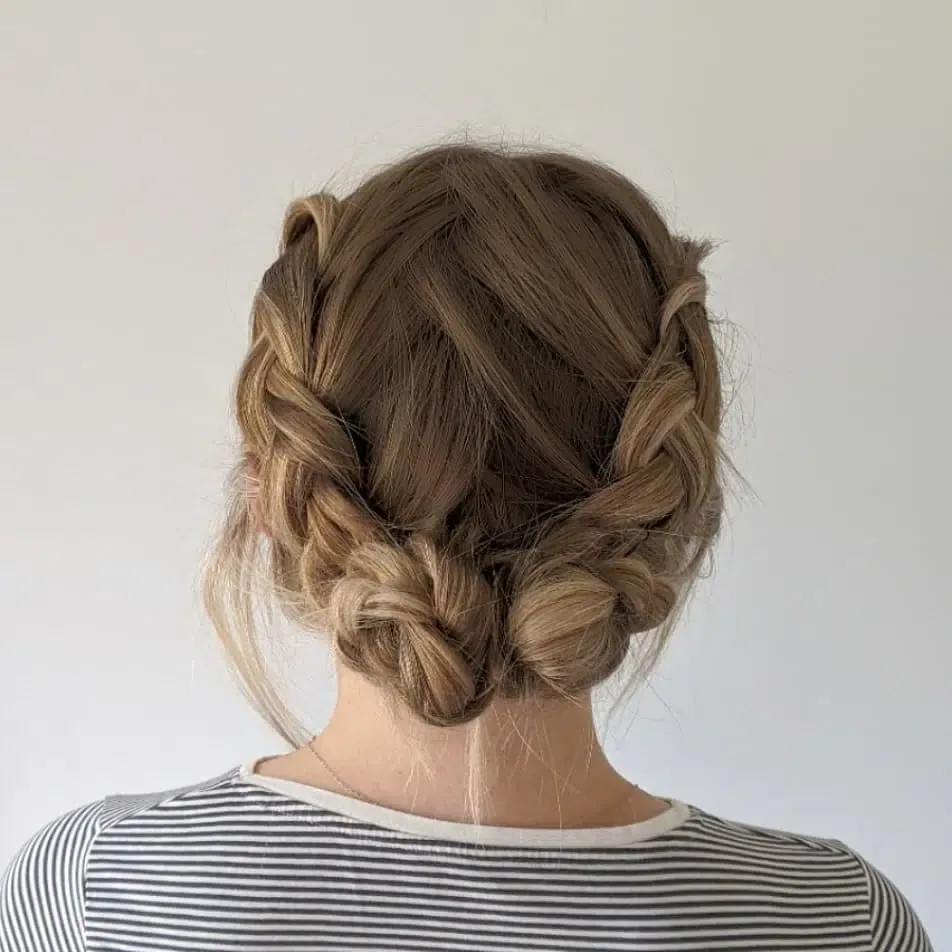 shoulder wavy blonde updo shown as a wedding guest hairstyle idea, featuring wavy texture